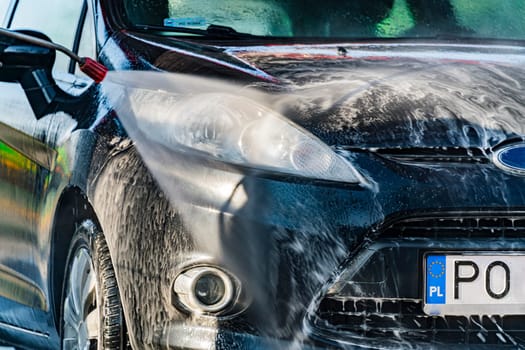 A vehicle in a coin-operated self-service car wash