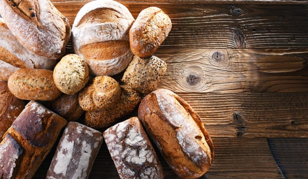 Composition with assorted bakery products on wooden table.