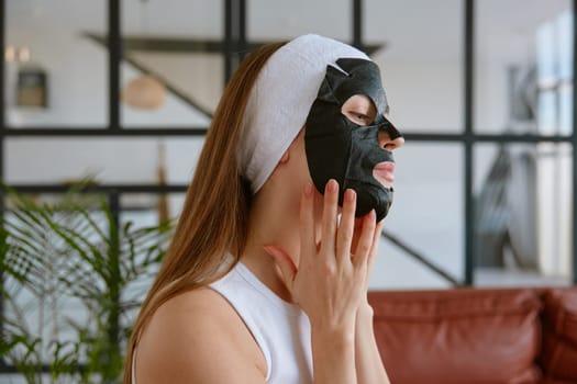 Young woman applying facial mask for healthy skin at home. Beauty morning freshness procedure and treatment therapy concept