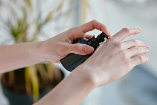 Closeup woman applying hand moisturizing lotion from natural SPA cosmetics. Cosmetology and skin rejuvenation concept