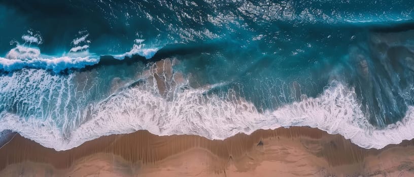 From above, the ocean's might unfurls in a canvas of frothing waves and swirling patterns, etching a natural masterpiece into the sandy shore. The aerial perspective reveals the water's dynamic motion