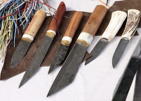 Cracow, Poland - April 11, 2023: Handmade imitations of medieval knives in knight camp at the festival of historical reconstruction