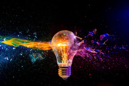 Vivid image of a light bulb shattering with a dynamic multicolored glass fragment splash