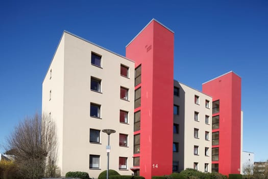 Modern, red and white residential building in spring, Findorff, Bremen, Germany