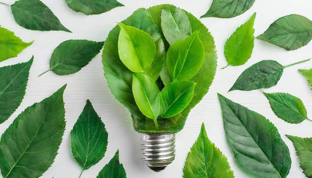 Green eco friendly lightbulb from fresh leaves top view. Energy saving, ecology and environment sustainable resources conservation concept...