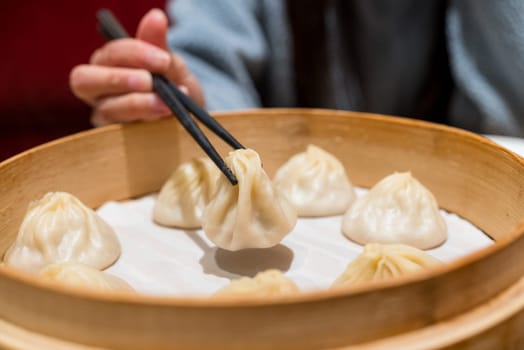Steamed xiaolongbao served in a traditional steaming basket