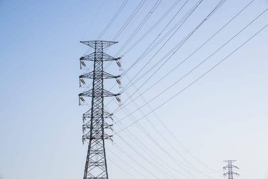 Pylon and high voltage powerline over the blue sky