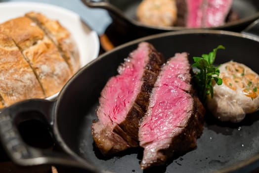 Juicy steak sliced on the cast iron