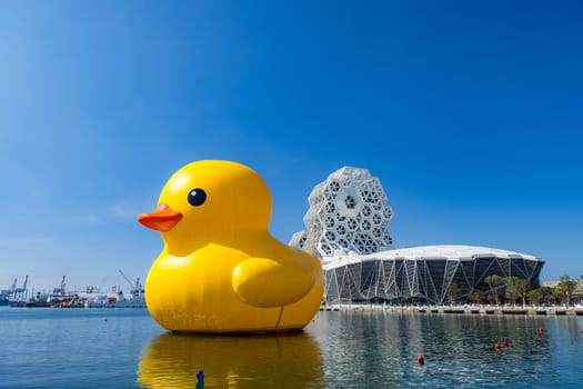 Taiwan, 01 February 2024: Kaohsiung Music Center with yellow duck floating over the bay
