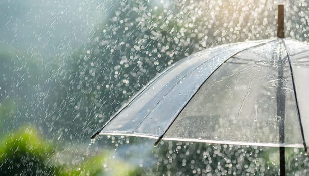 Transparent umbrella under rain against water drops splash background. Rainy weather concept.