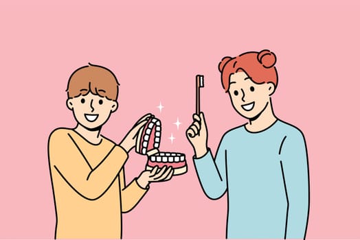 Happy children show rules brushing teeth and using dental toothbrush to get rid of bacteria in mouth