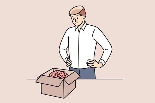 Man took brain out of head and put it in cardboard box, for concept of removing facts from memory. Stupid guy received new brain in package to quickly become smarter and acquire new skills