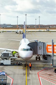 Berlin, Germany - February 7, 2022: airfield with lufthansa aircraft and view to runway at Willy Brandt airport in Berlin.
