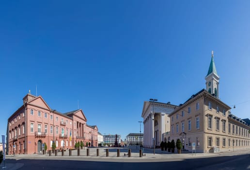 Karlsruhe, Germany - April 17, 2022: Karlsruhe market square with red sandstone monuments, city hall and other public govermental buildings in historic style.