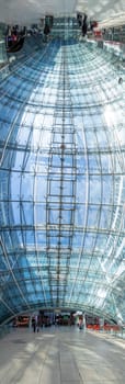Frankfurt, Germany - May 13, 2022: people in the modern business and train station building the square at the airport in Frankfurt, Germany.