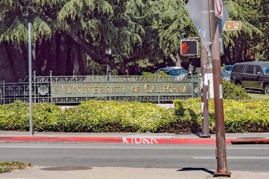 Oakland, USA - May 18, 2022: signage University of California in golden letters at the entrance of the university campus in Oakland.