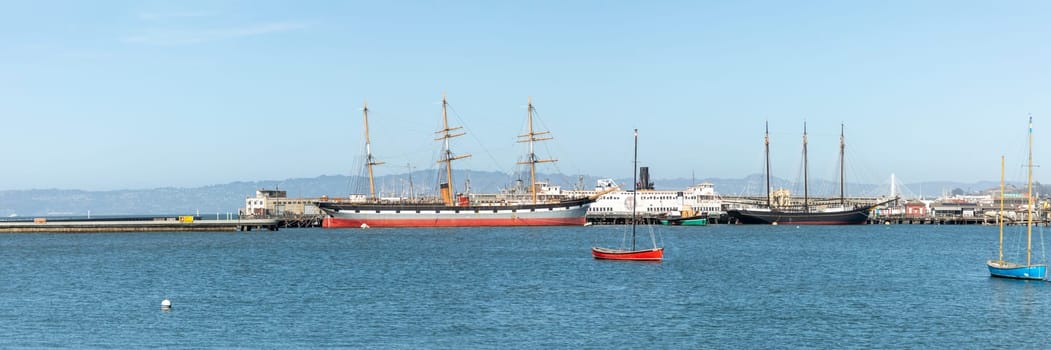 San Francisco, USA - May 18, 2022: panoramic view to fishermans wharf area in San Francisco with skyline and old traditional boats at Hyde street pier.