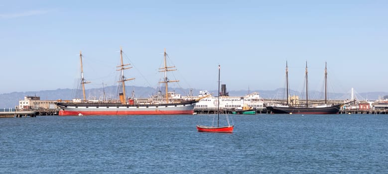 San Francisco, USA - May 18, 2022: panoramic view to Hyde pier in San Francisco with historic sailor Balclutha and other ships.