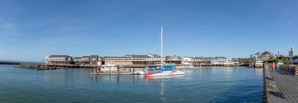 San Francisco, USA - May 18, 2022: sailing boats at the old historic pier 39 in San Francisco in early morning.