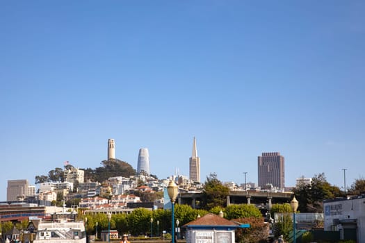 San Francisco, USA - May 18, 2022: skyline of San Francisco with skyscraper and pyramid in early morning light seen from pier 36.