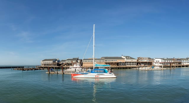 San Francisco, USA - May 18, 2022: sailing boats at the old historic pier 39 in San Francisco in early morning.