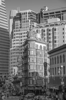 San Francisco, USA - May 18, 2022:  Old copper-green Columbus tower also called sentinel building with the transatlantic pyramid in the background.