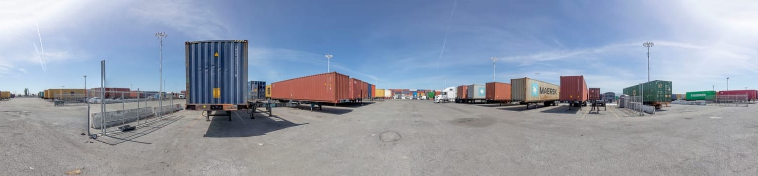 Oakland, USA - May 18, 2022: container at Oakland harbor in panoramic view. Oakland harbor serves San Francisco with goods.
