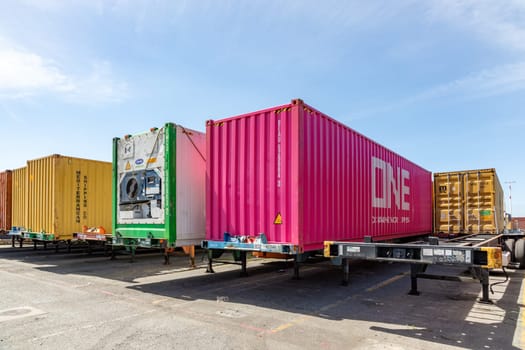 Oakland, USA - May 18, 2022: container at Oakland harbor in panoramic view. Oakland harbor serves San Francisco with goods.
