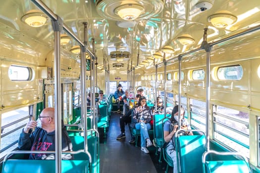 San Francisco, USA - May 20, 2022:  people in the old classic streetcar bus in vintage style downtown San Francisco