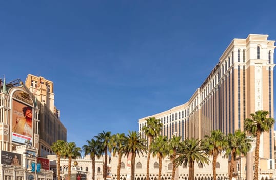 Las Vegas, USA - May 23, 2022: view of the Venetian Hotel and casino with palm trees in front.