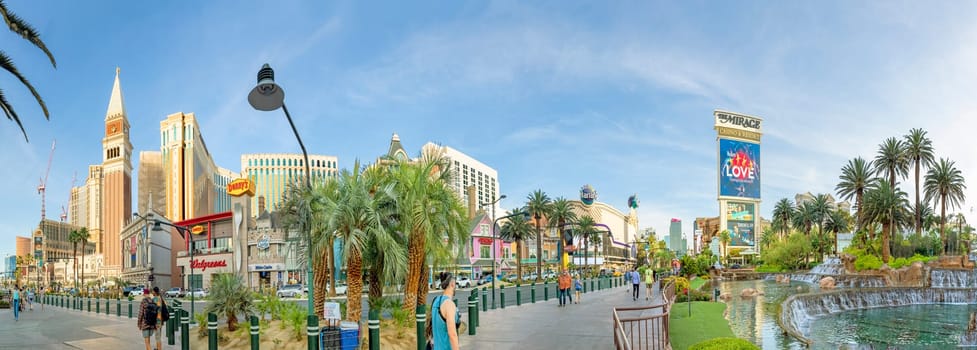 Las Vegas, USA - May 23, 2022: panoramic view of the Venetian Hotel and other famous hotels and casino with palm trees in front at the strip.