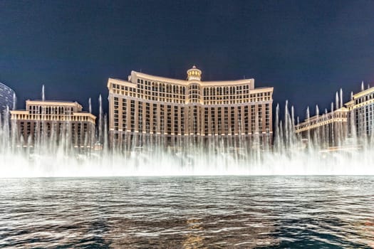 Las Vegas, Nevada, USA - May 23, 2022: The Fountains of Bellagio at night. This feature performs choreography with water, music and light in front of the Bellagio hotel and casino.