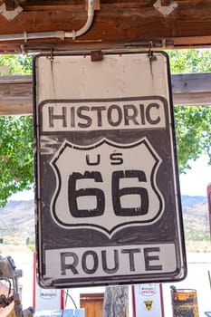 Hackberry, USA - May 25, 2022: historic route 66 sign at an old wooden wall.