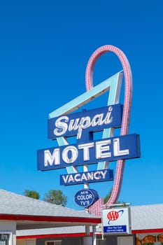 Seligman, USA - May 25, 2022: Motel and Route 66 sign Supai on Historic Route 66. Built in 1904. The neon light lost color but is still in use.