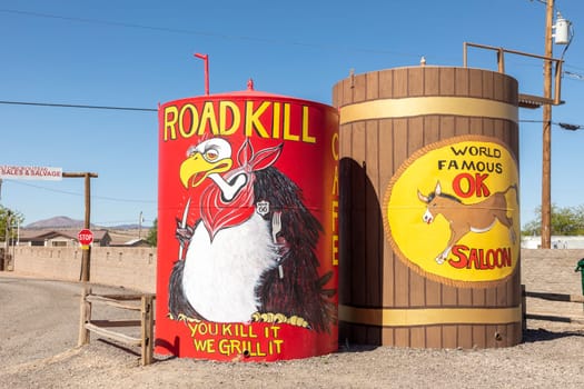 Seligman, USA - May 25, 2022: advertising for Roadkill cafe with slogan you kill it we grill it and Saloon at route 66 at a huge water tank in Seligman, Route 66.