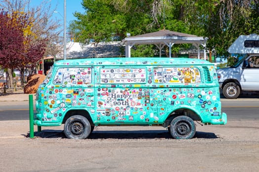 Seligman, USA - May 25, 2022: old vintage VW bully car or transporter covered with badges at route 66 in Seligman, Arizona.