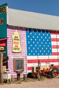 Seligman, USA - May 25, 2022: vintage historic souvenir shop at route 66 with stars and stripes painted at  facade as decoration in Seligman, USA.