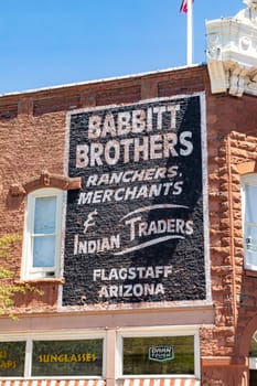 Flagstaff, USA - May 26, 2022: old historic brick building with advertising downtown Flagstaff.