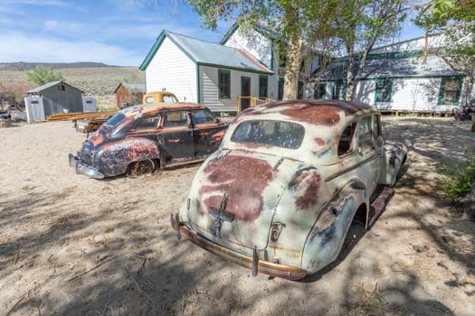Benton hot Springs, USA - June 3, 2022: old vintage rusty car wrecks at an old abandoned farm in USA