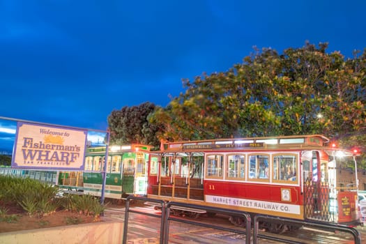 San Francisco, USA - June 5, 2022: old cable car ready to start at Fishermans wharf in San Francisco by night.