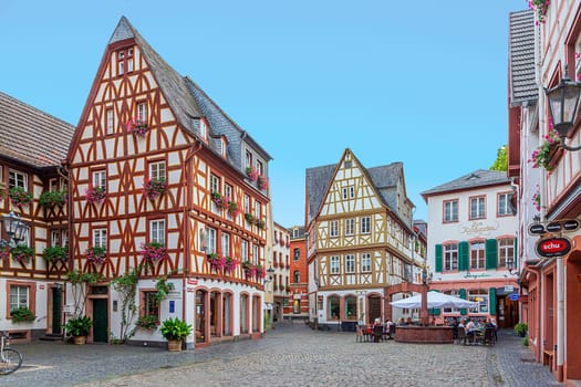 Mainz, Germany - August 27, 2022: Traditional German half timbered houses at Mainz city centre. Cobble stone street.