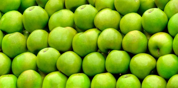 Tasty organic green apples assortment from bio farm. Summer fruit texture background. Healthy food pattern design.
