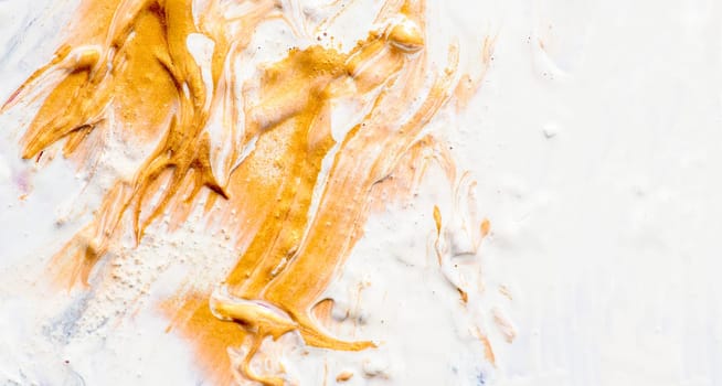 Golden and white oil paint on artist canvas. Fine art gold acrylic color closeup. Abstract creative background texture.