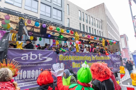 Osnabrueck, Germany - February 19, 2023: people celebrate the carnival parade in Osnabrueck on a rainy day.