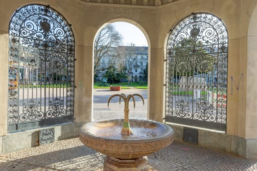 Wiesbaden, Germany - April 4, 2023: The Kochbrunnen (in German: boil fountain) in Wiesbaden is the most famous hot spring in city. It is a sodium chloride hot spring.