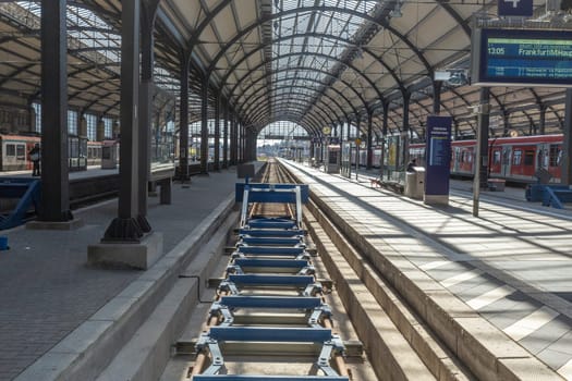 Wiesbaden, Germany - April 4, 2023:  people wait in the train station for departure in classicistic train station in Wiesbaden, the smaller copy of Frankfurt Train station.