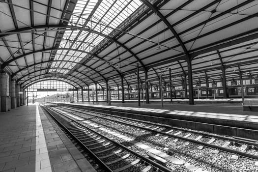 Wiesbaden, Germany - April 4, 2023:  people wait in the train station for departure in classicistic train station in Wiesbaden, the smaller copy of Frankfurt Train station.