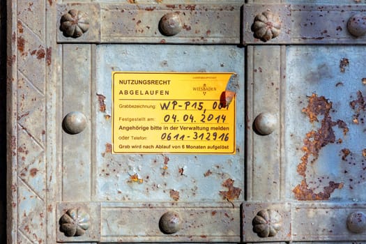 Wiesbaden, Germany - February 27, 2023: information at an old grave at cemetery Wiesbaden north with message - right of usige exceed, grave will be reused after April 4, 2014 with 6 Months of goodwill time.