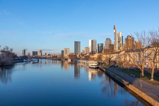 Frankfurt, Germany - February 28, 2023: scenic view to skyline of Frankfurt am Main with reflection of the skyline in river Main.
