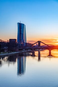 Frankfurt, Germany - February 28, 2023: scenic view to skyline of Frankfurt am Main with reflection of the european central bank in river Main.